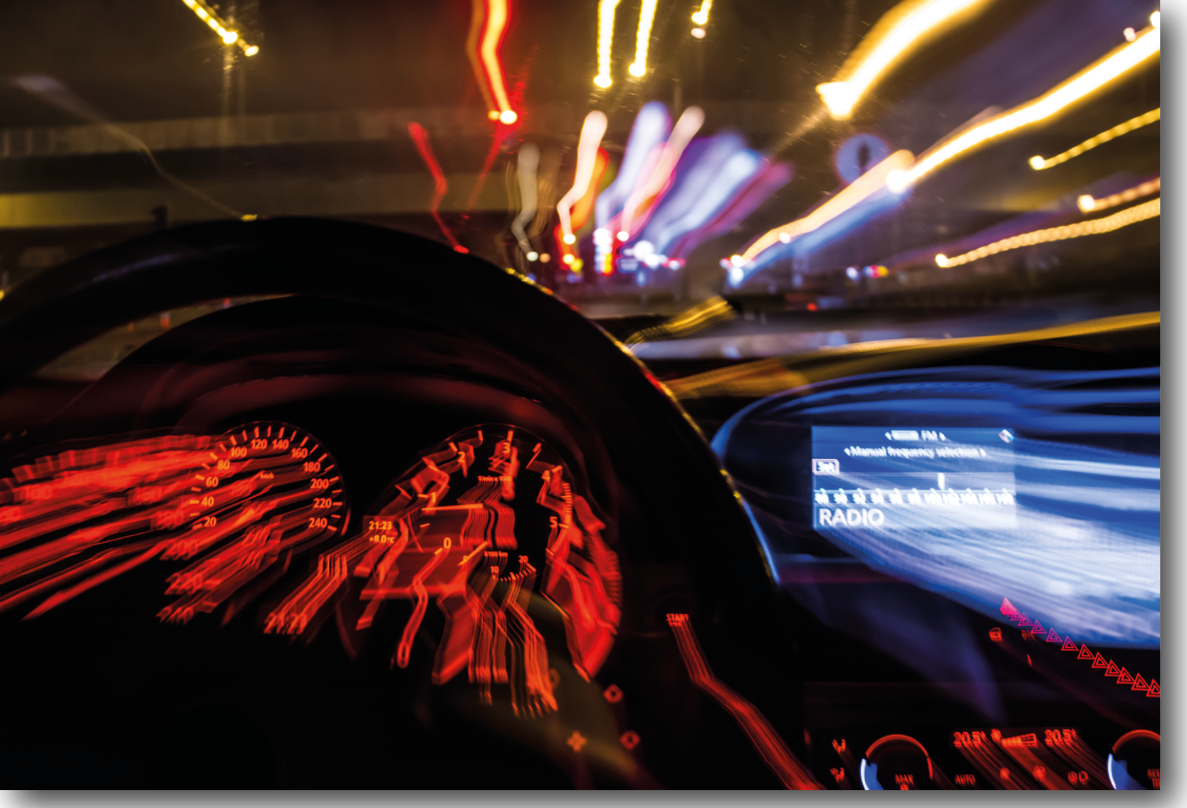 A picture of a point of view angle of a person behind the wheel of a car, with blurred vision