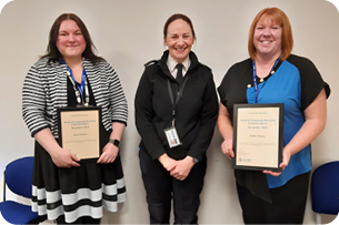 PNLD staff receiving a commendation certificate